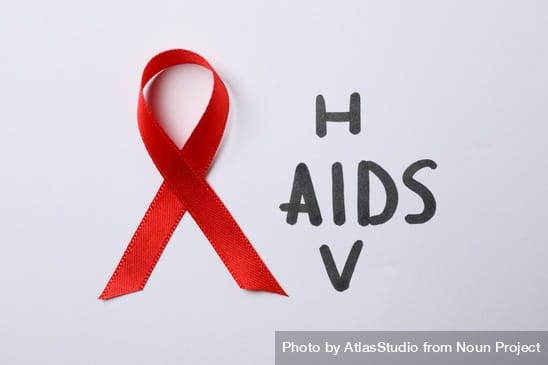 Red awareness ribbon and words HIV and AIDS on blank background, close up by AtlasStudio from Noun Project (CC BY-NC-ND 2.0)